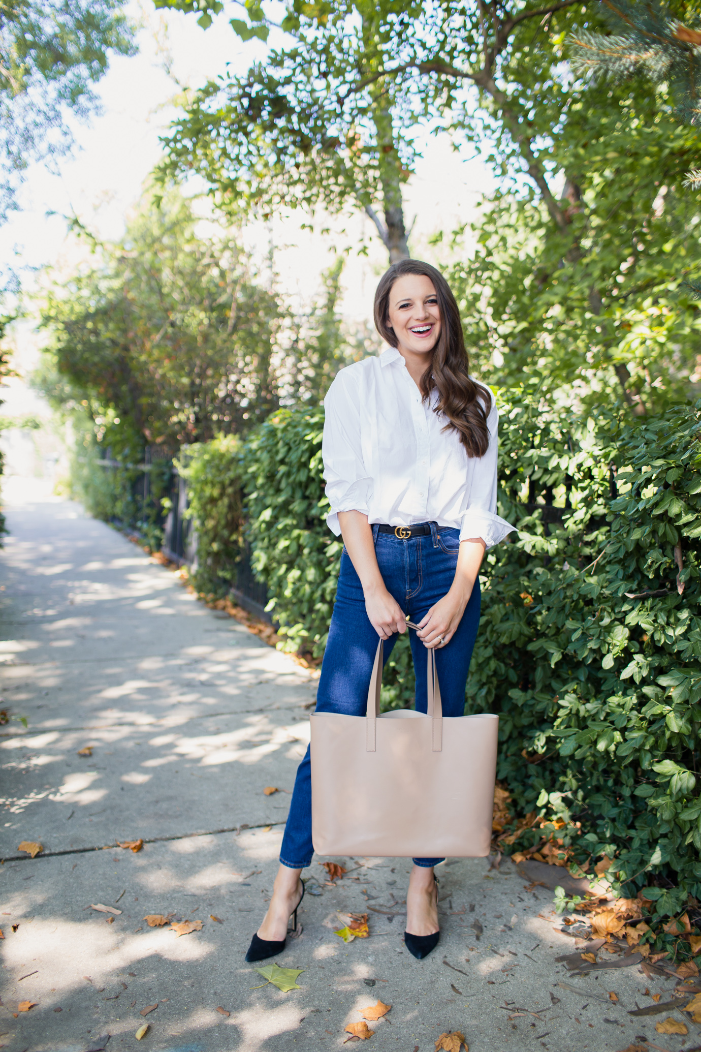 Pumps with a white button-down and dark-wash denim