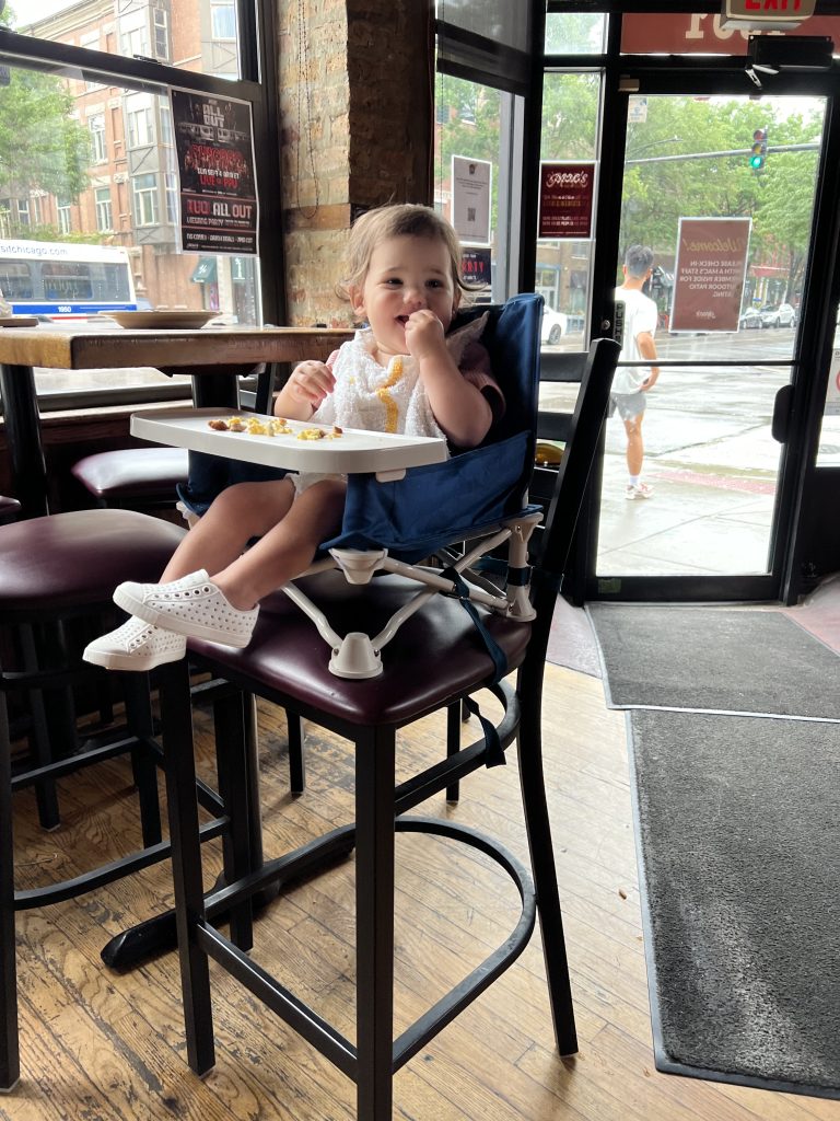 toddler in portable high chair