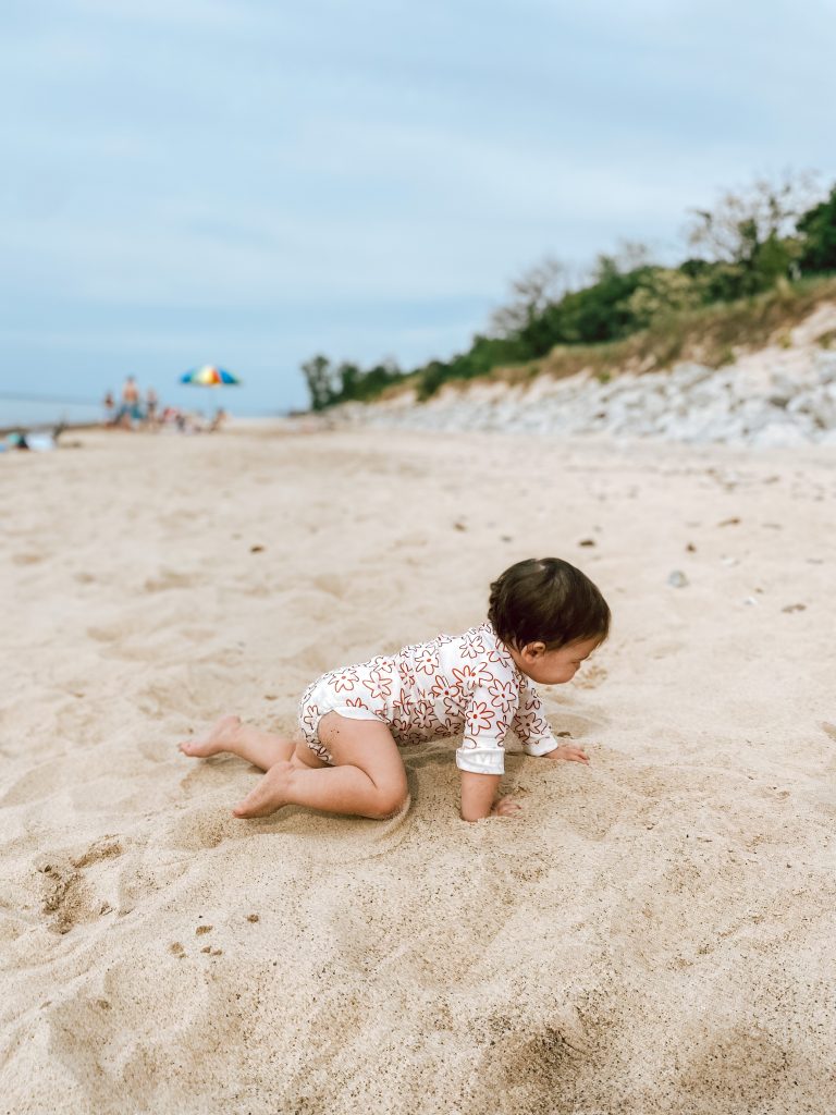 baby crawling in the sand