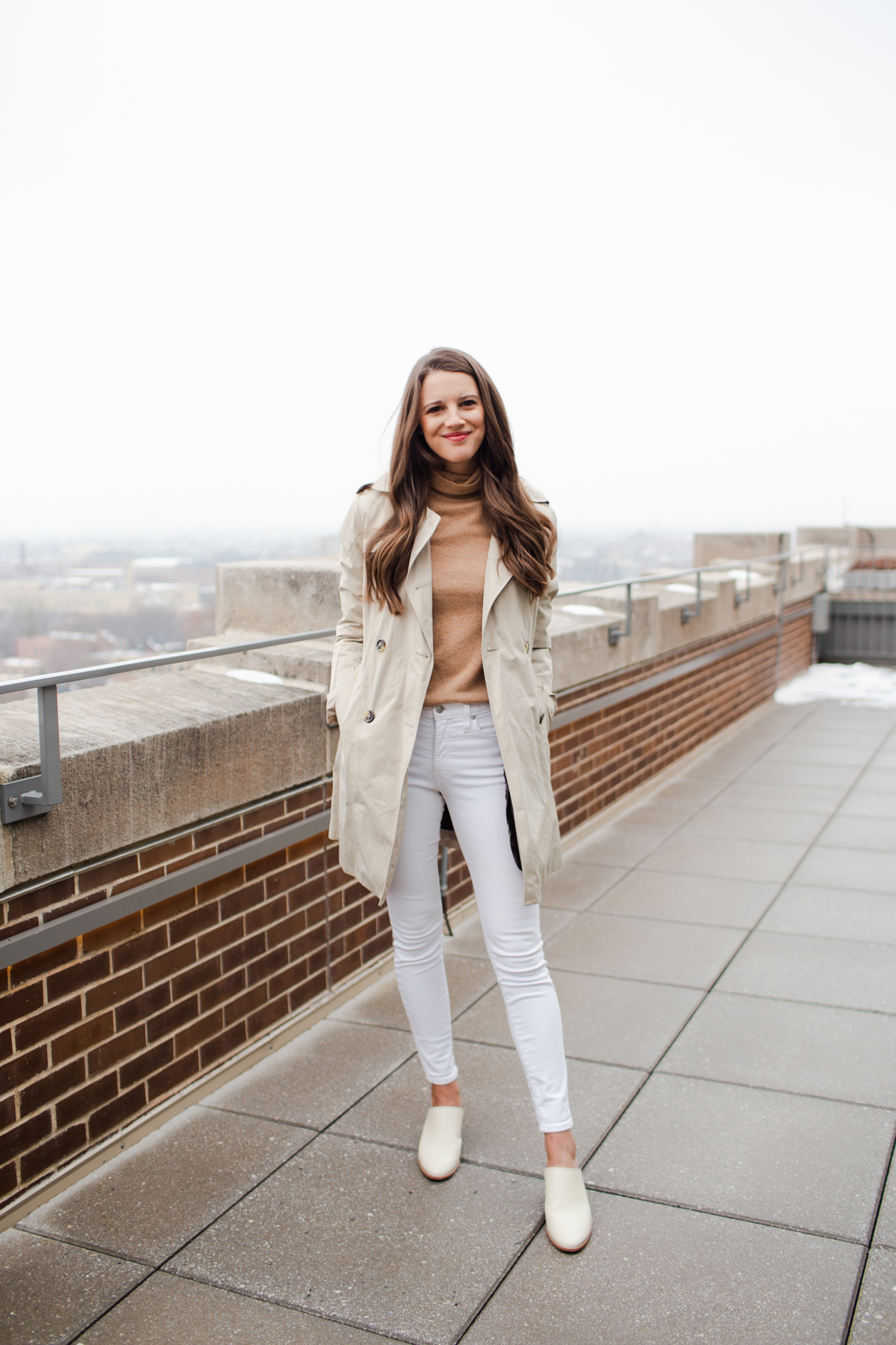 Winter white jeans outfit #1: With mules, camel turtleneck, and a neutral coat