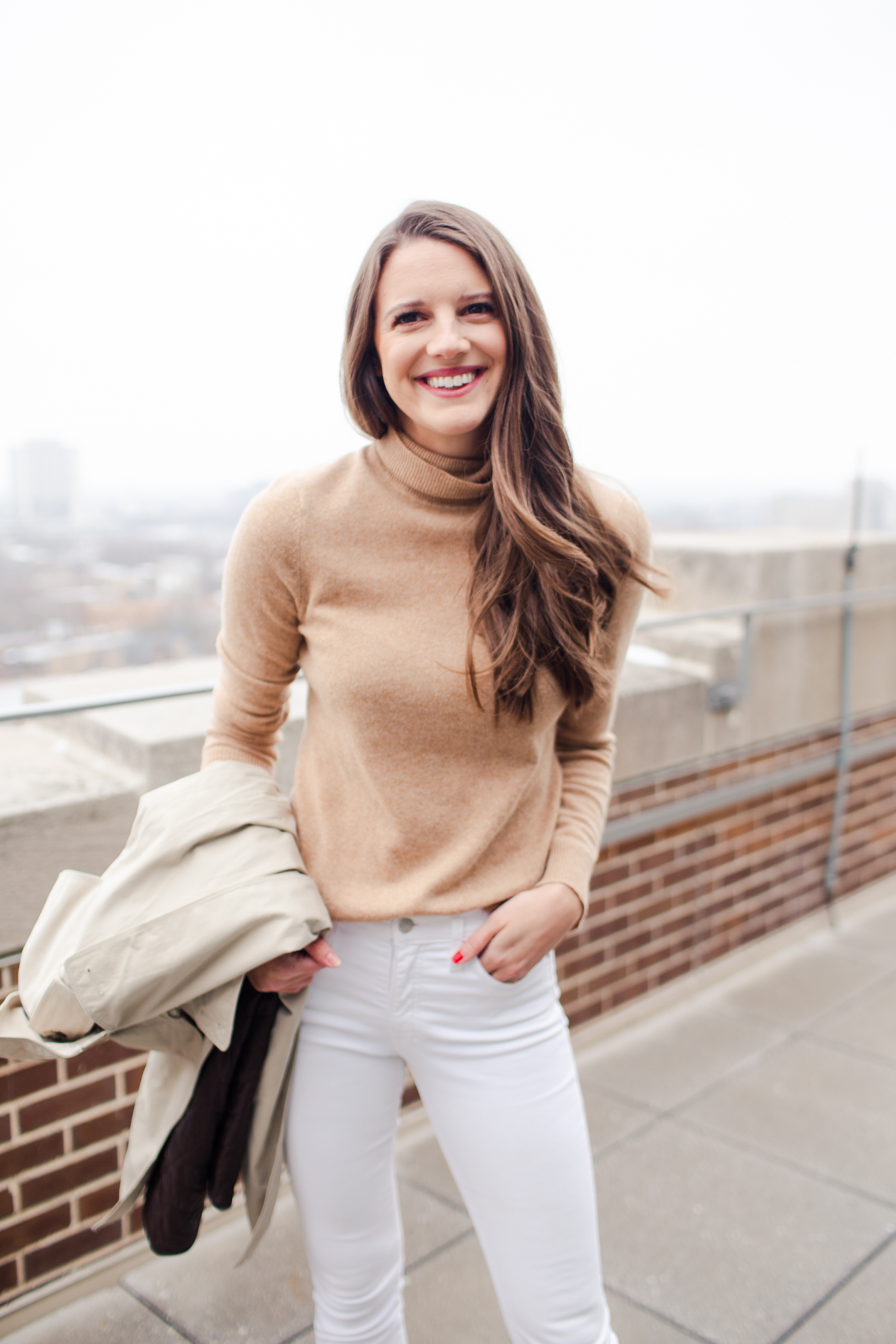 Winter white jeans outfit #1: With mules, camel turtleneck, and a neutral coat