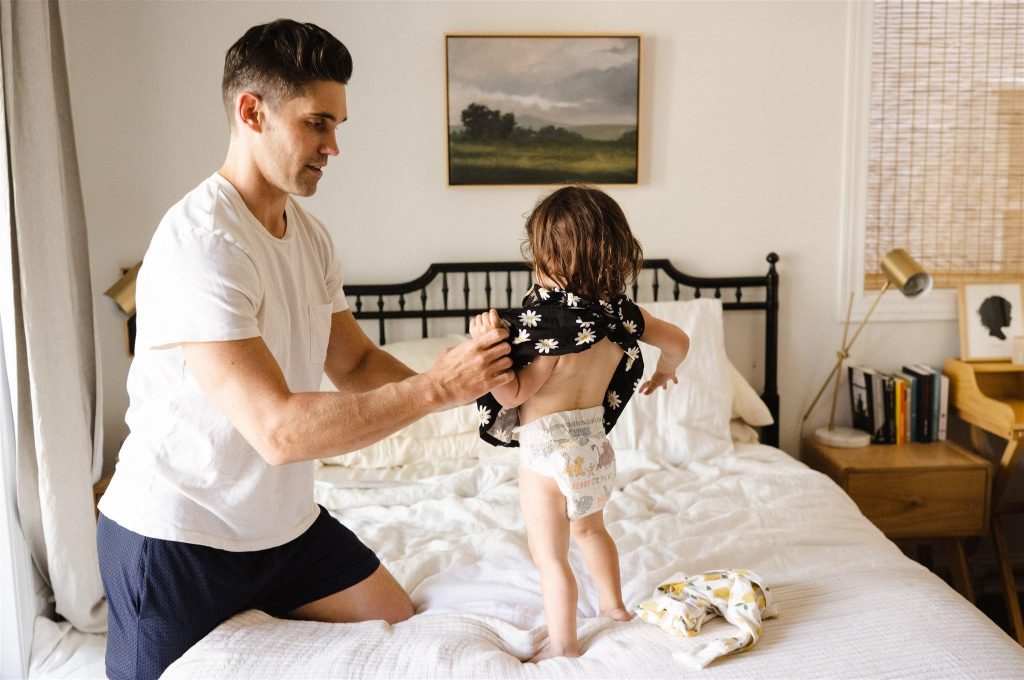 dad dressing up toddler